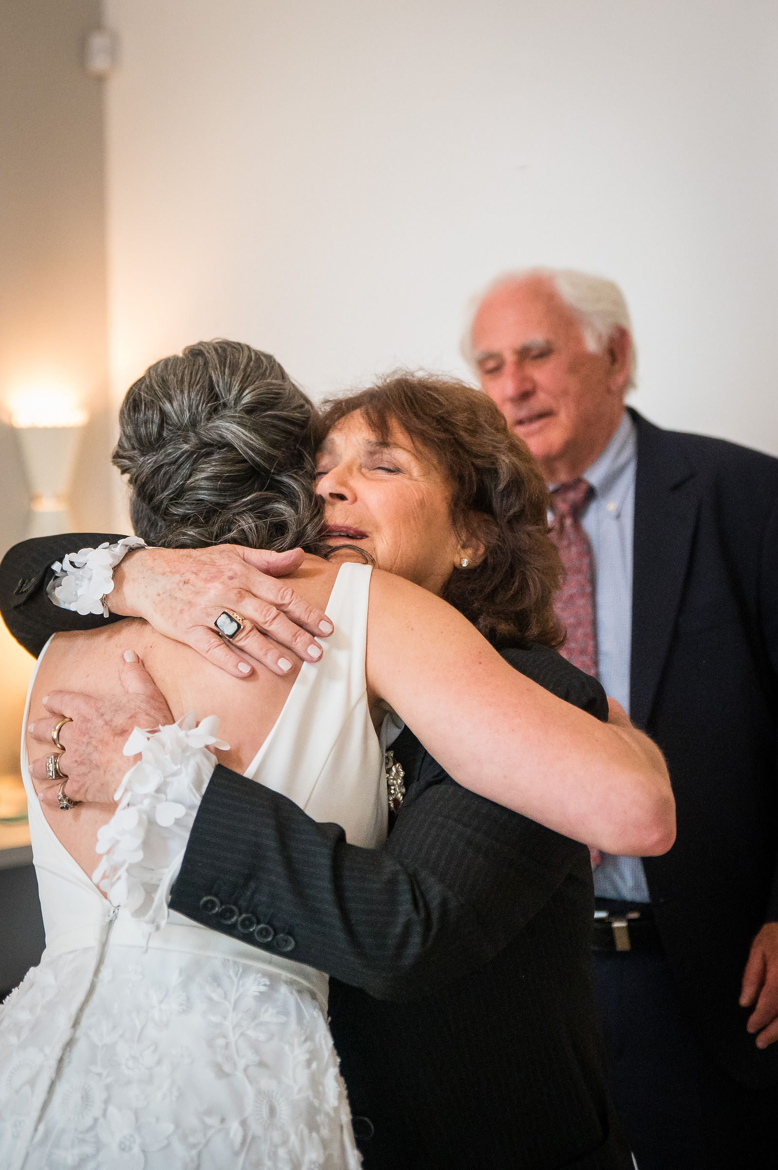 Emotional embrace between a bride and her mother on the wedding day