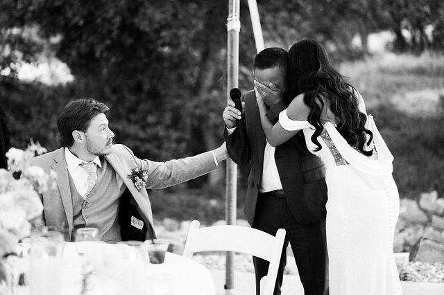 A couple reacting to a heartfelt wedding speech