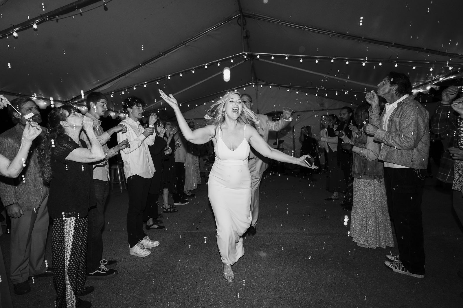 A couple leaving their wedding in a rush of celebration at Teleli Golf Club in California.