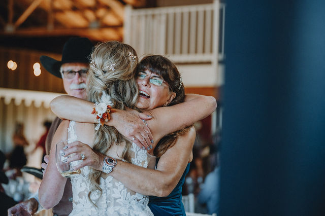 An emotional family embrace at a wedding