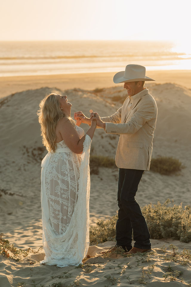 A couple together by the coast at sunset