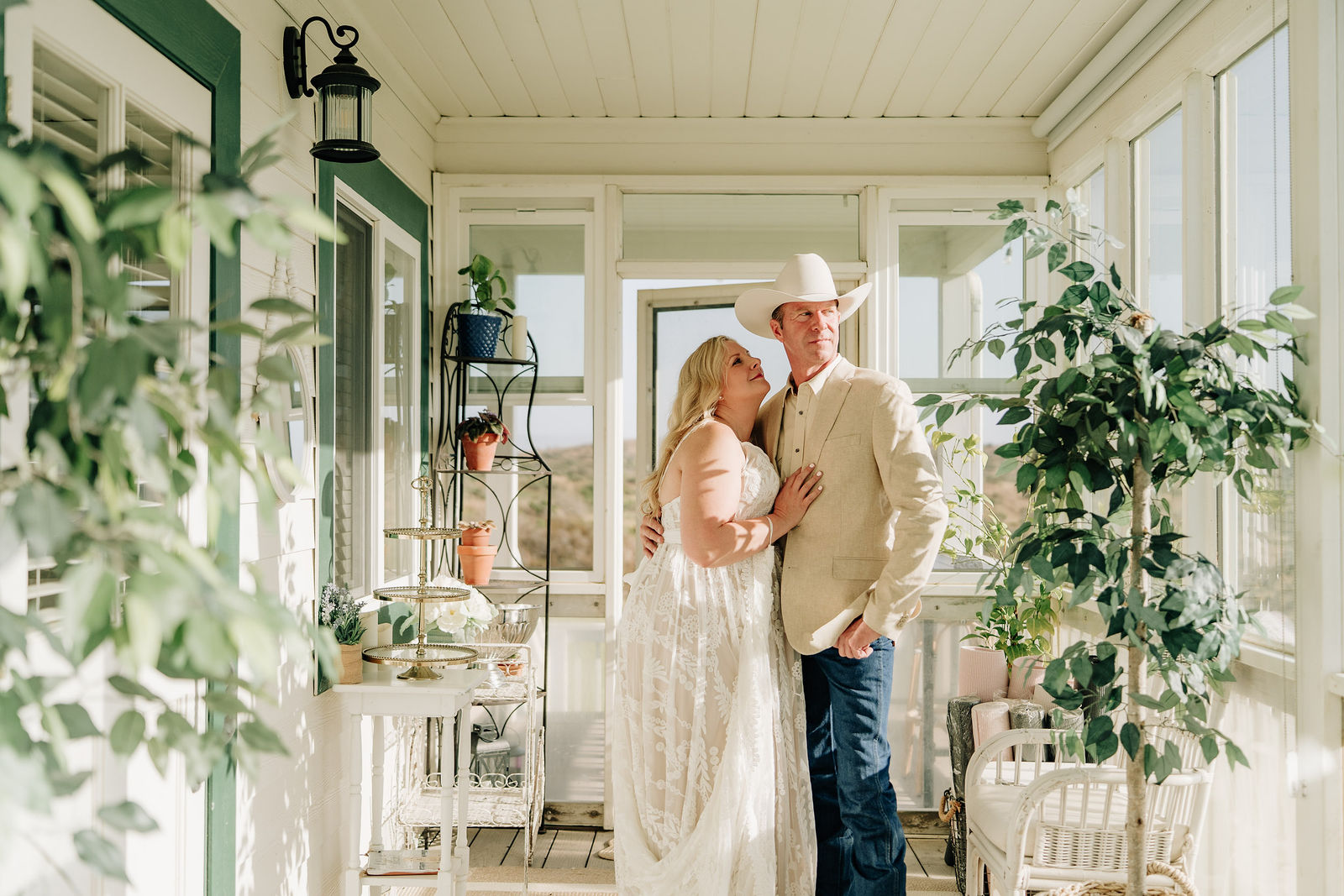 A couple together in a sunlit getting-ready space before their elopement.