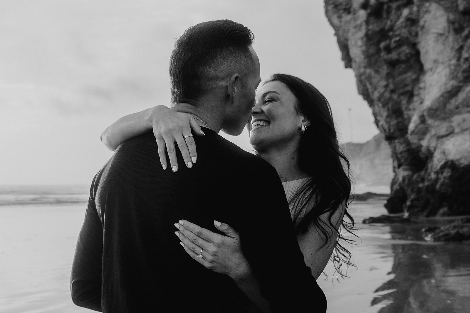 A black-and-white coastal embrace