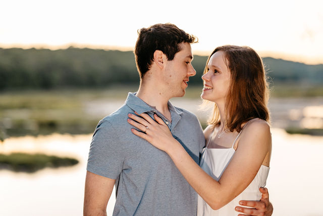 A bride and groom pose during golden hour at their wedding