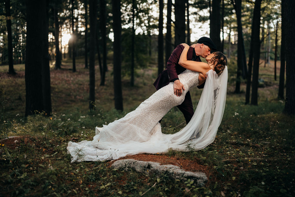 Mike dipping Kristin for a kiss in the woods
