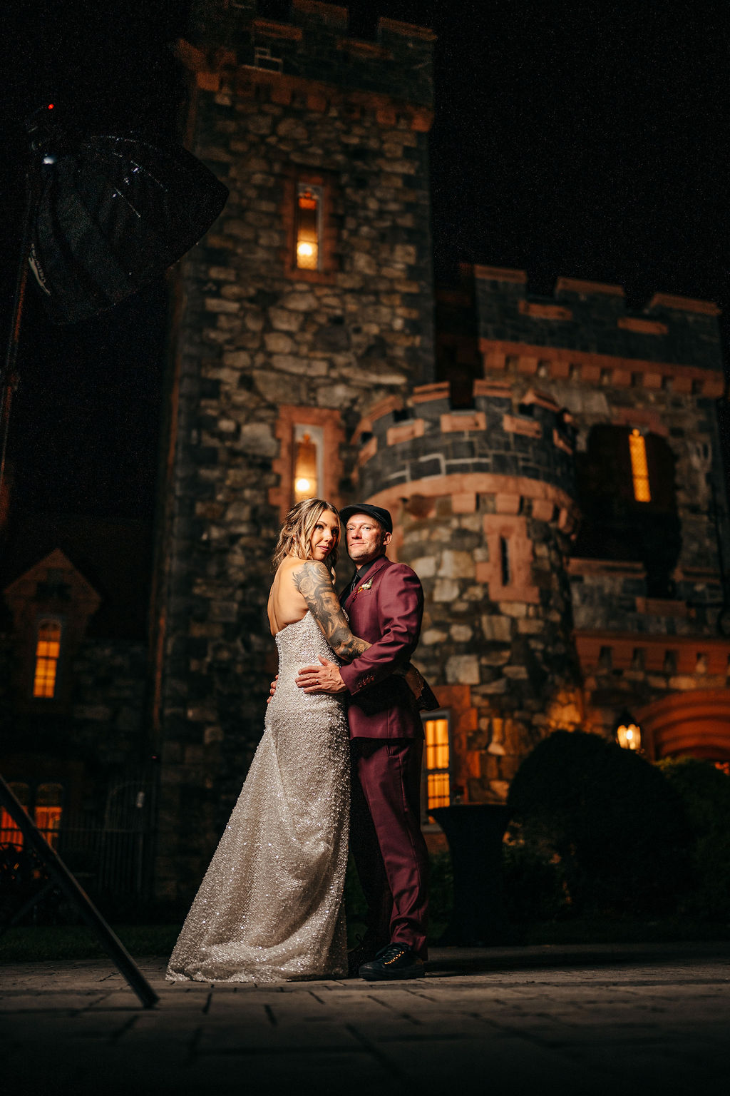Kristin and Mike embracing in front of Searles Castle at night