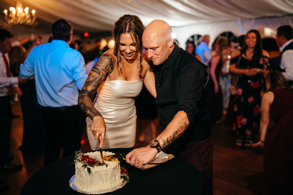 Kristin and Mike cutting their wedding cake