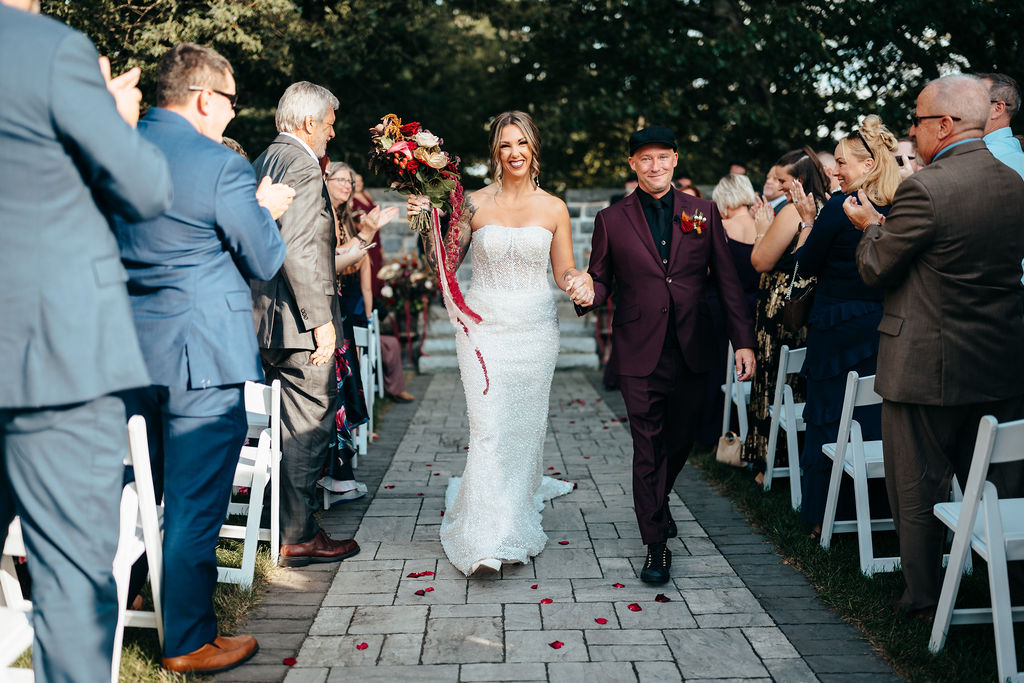 Kristin and Mike walking back down the aisle as newlyweds