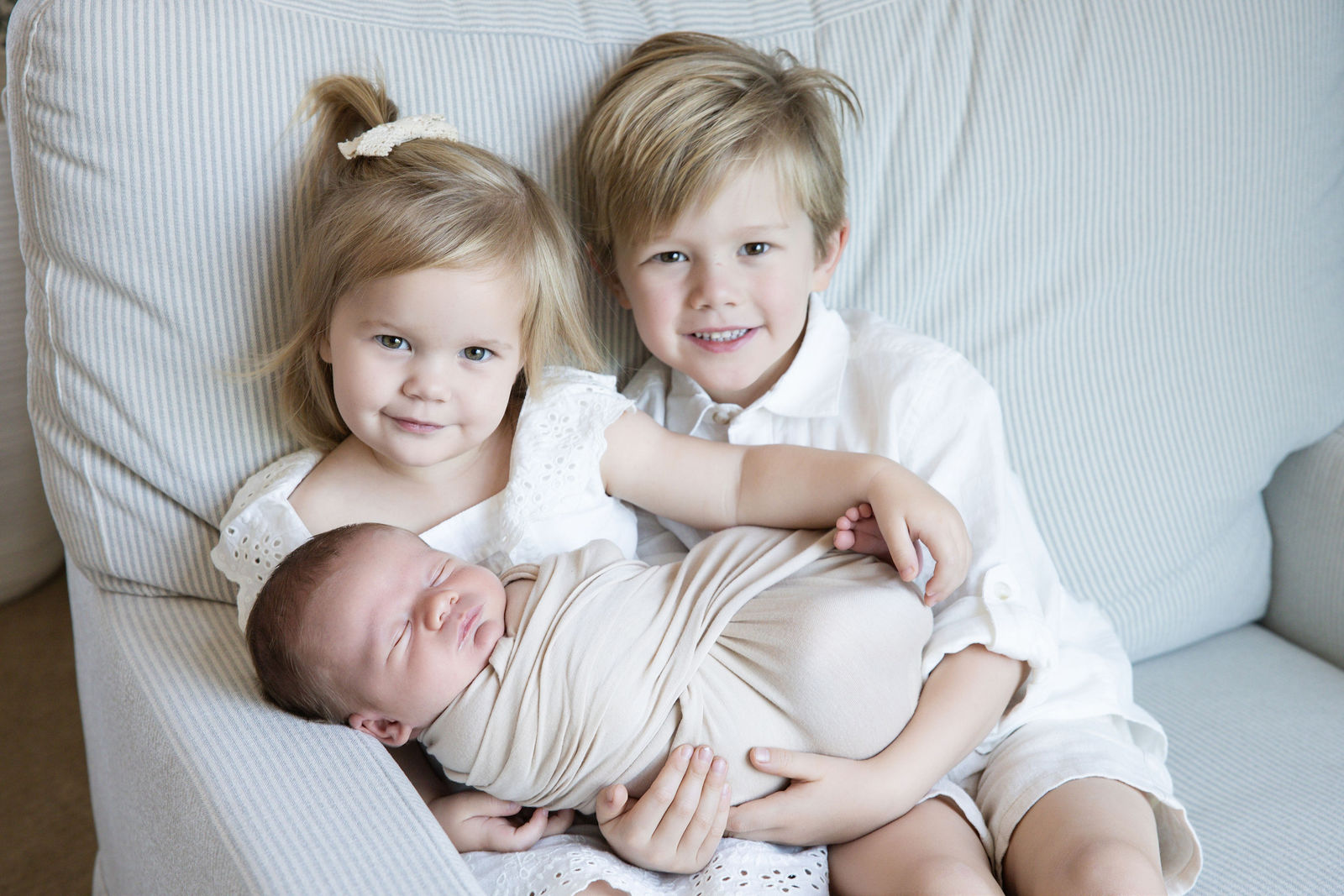 Family photographed with their newborn during a relaxed in-home session