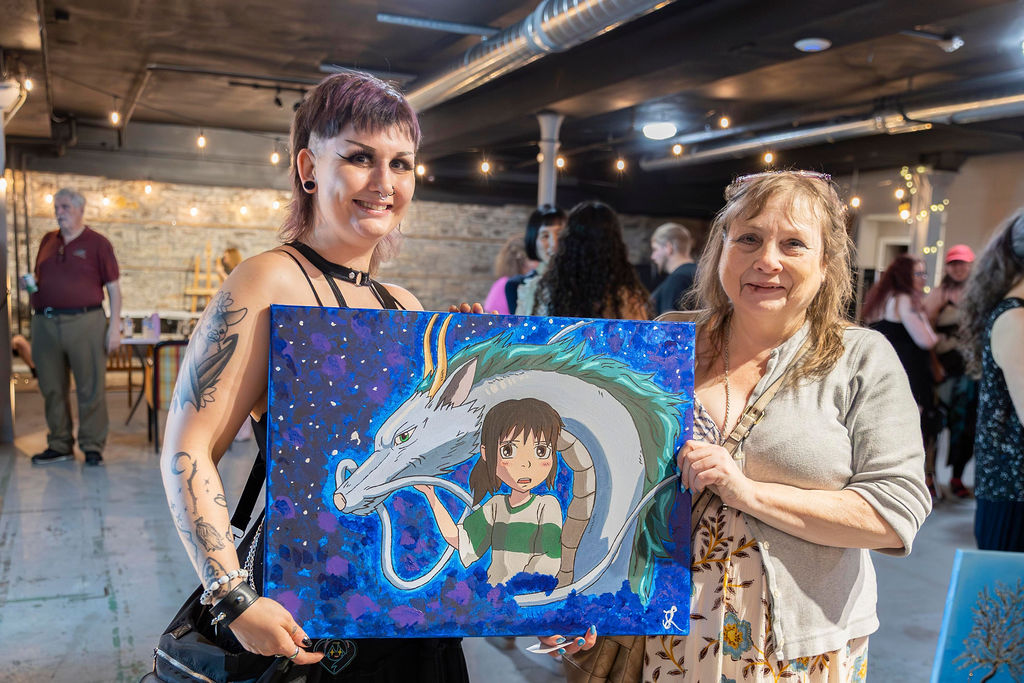 A guest holding a painting