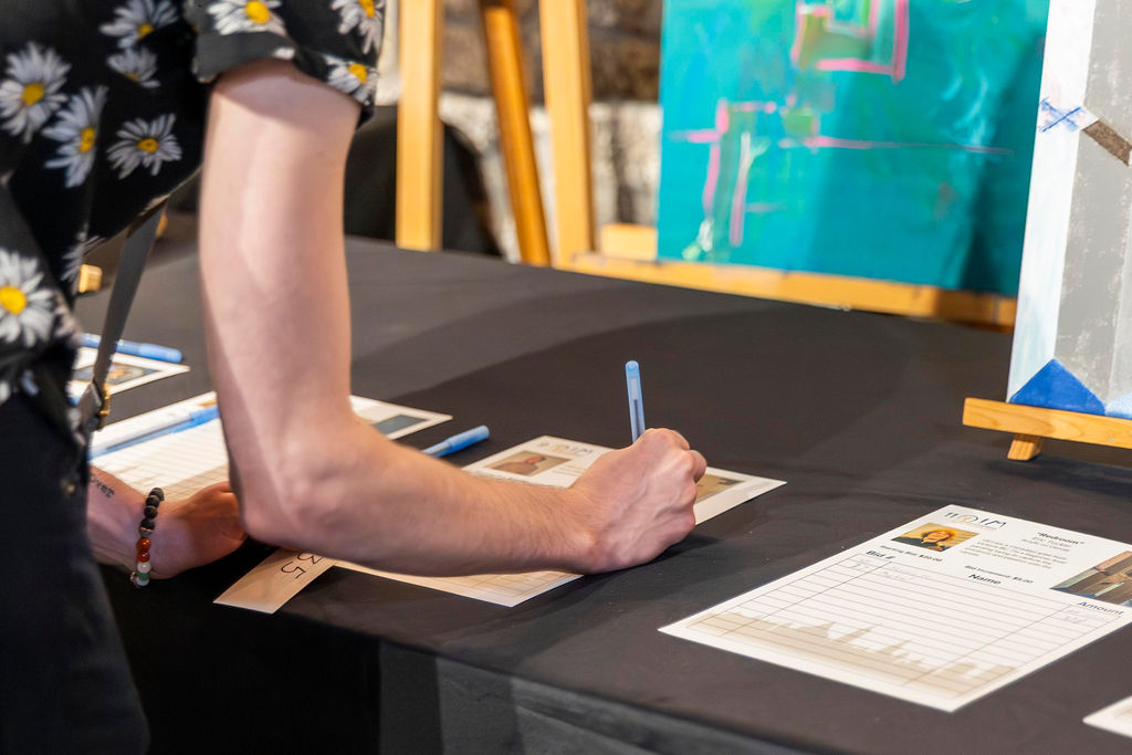 A guest placing a bid in the auction