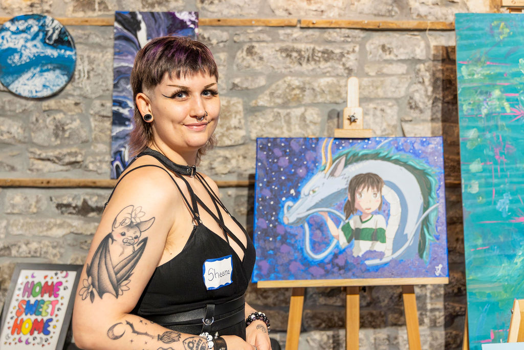 An artist with her painting