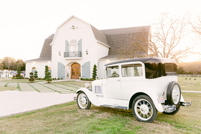 Horizontal venue exterior with vintage car.