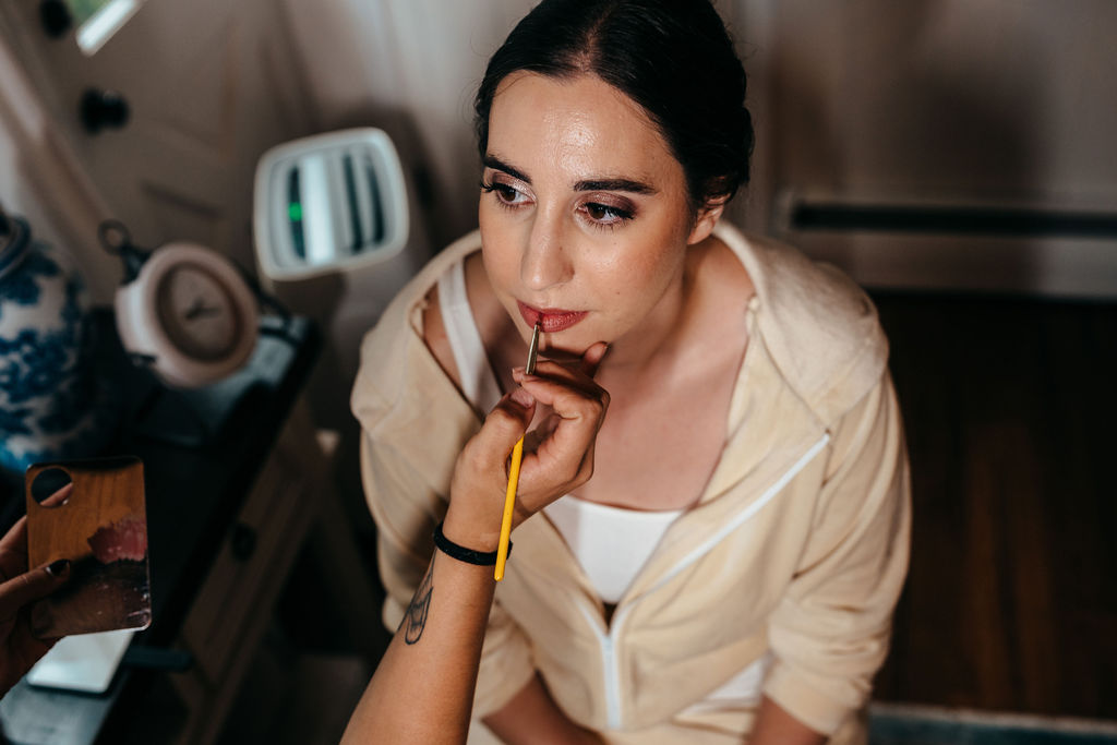 Bride having makeup applied before the ceremony