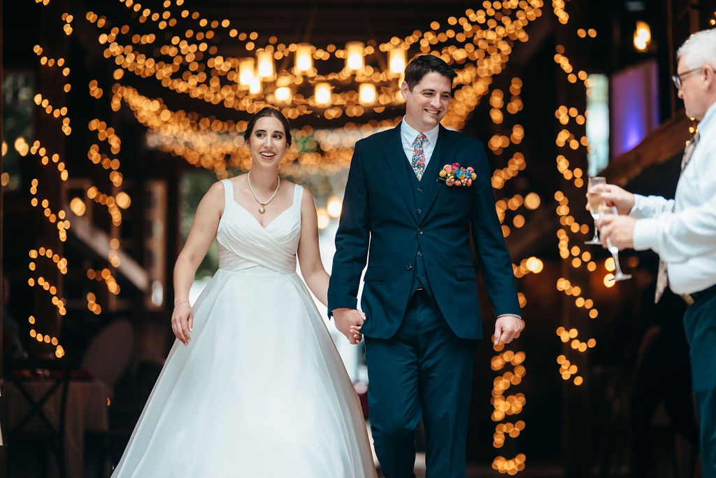 Couple walking into the reception holding hands