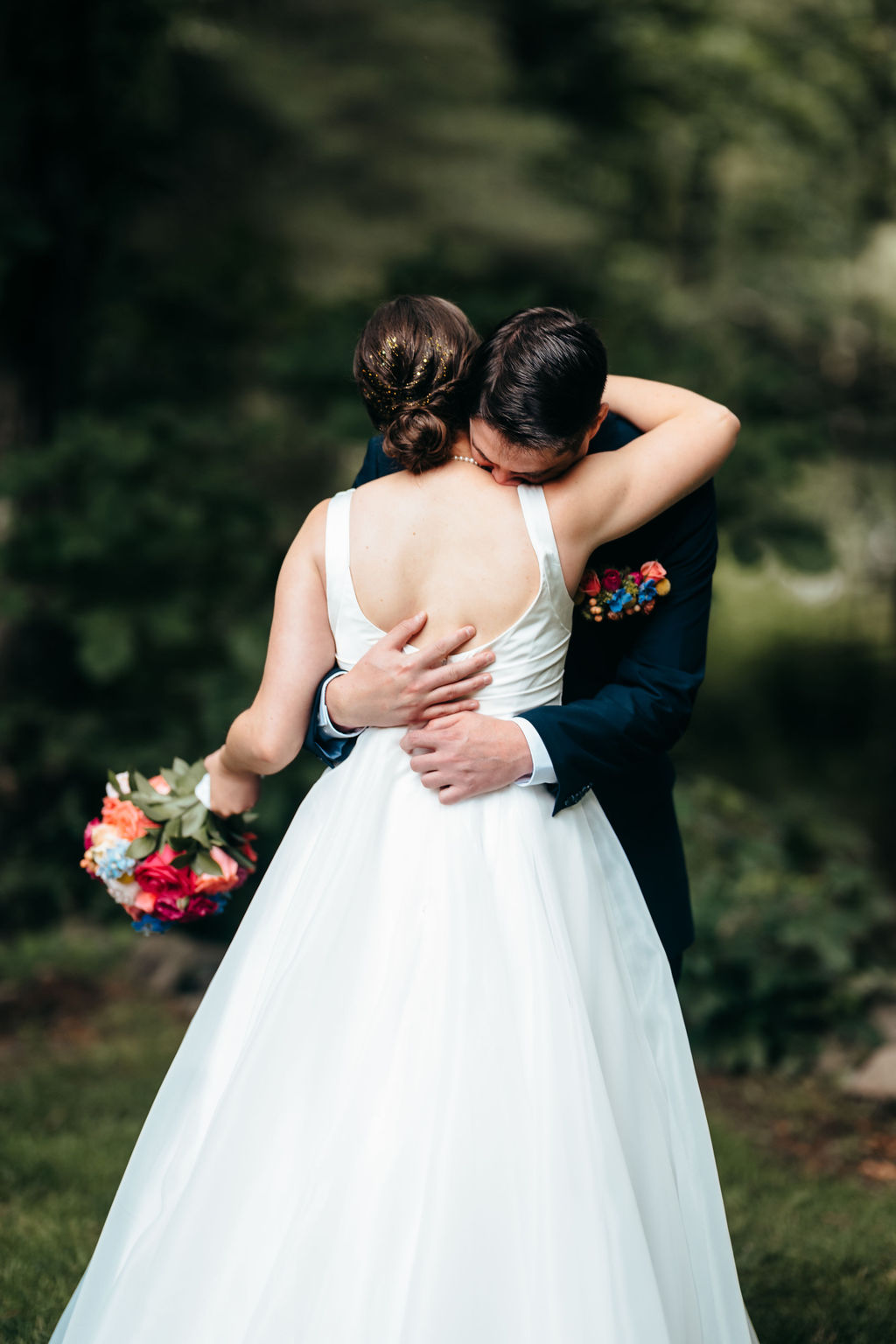Couple embracing during their first look, seen from behind