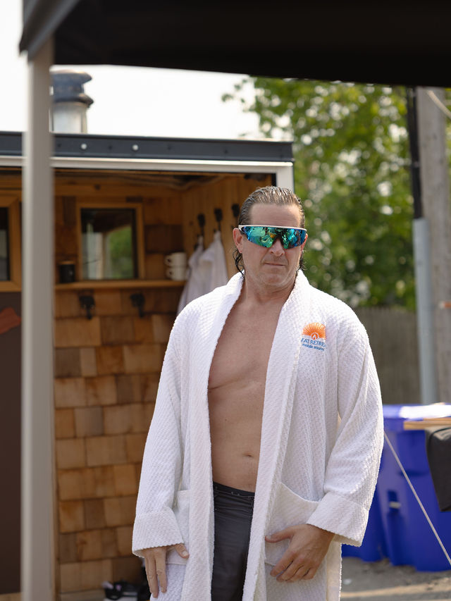Guest wearing a Heat Retreat terry cloth robe outside the mobile sauna