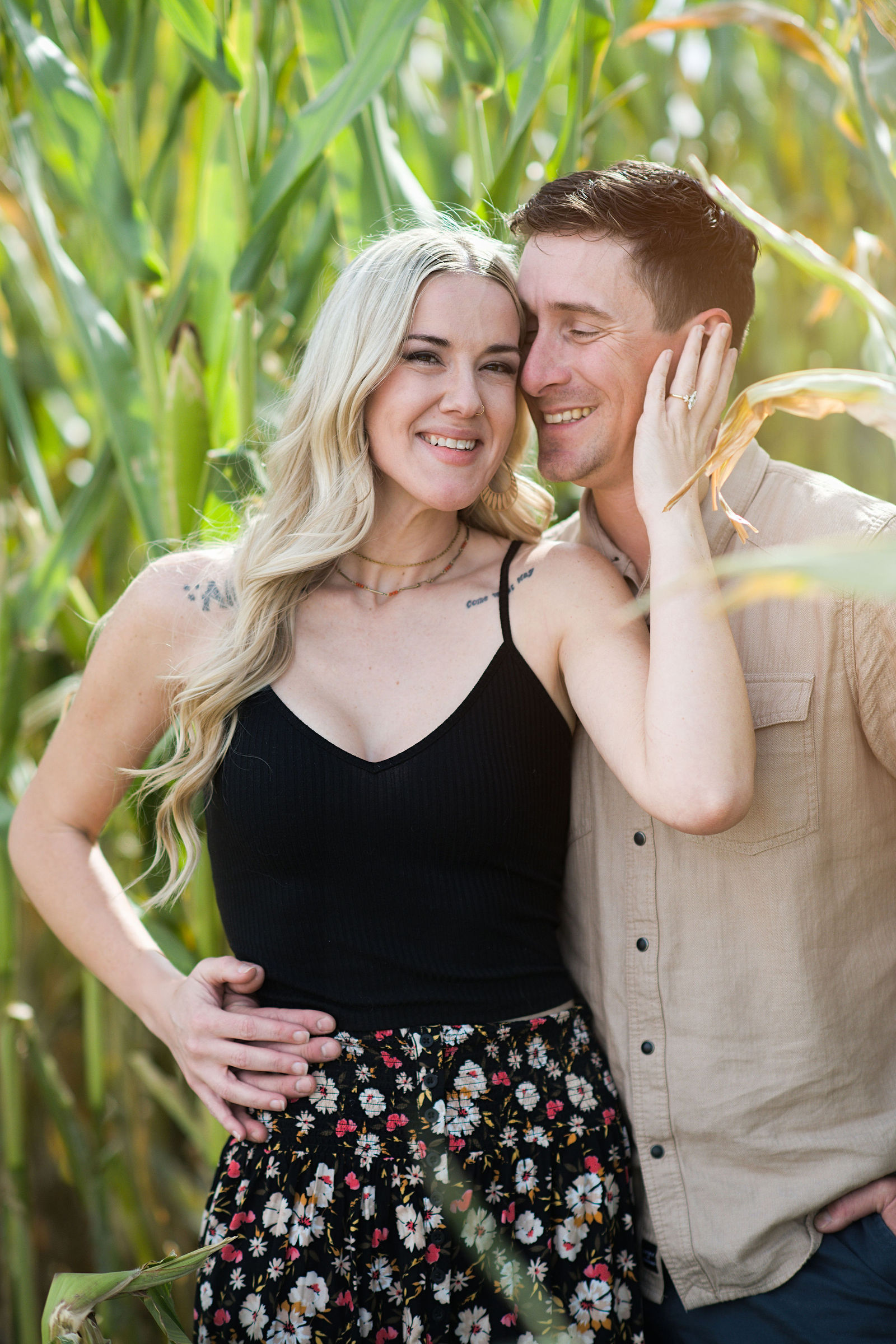 Couple sharing a sweet moment beside autumn corn husks