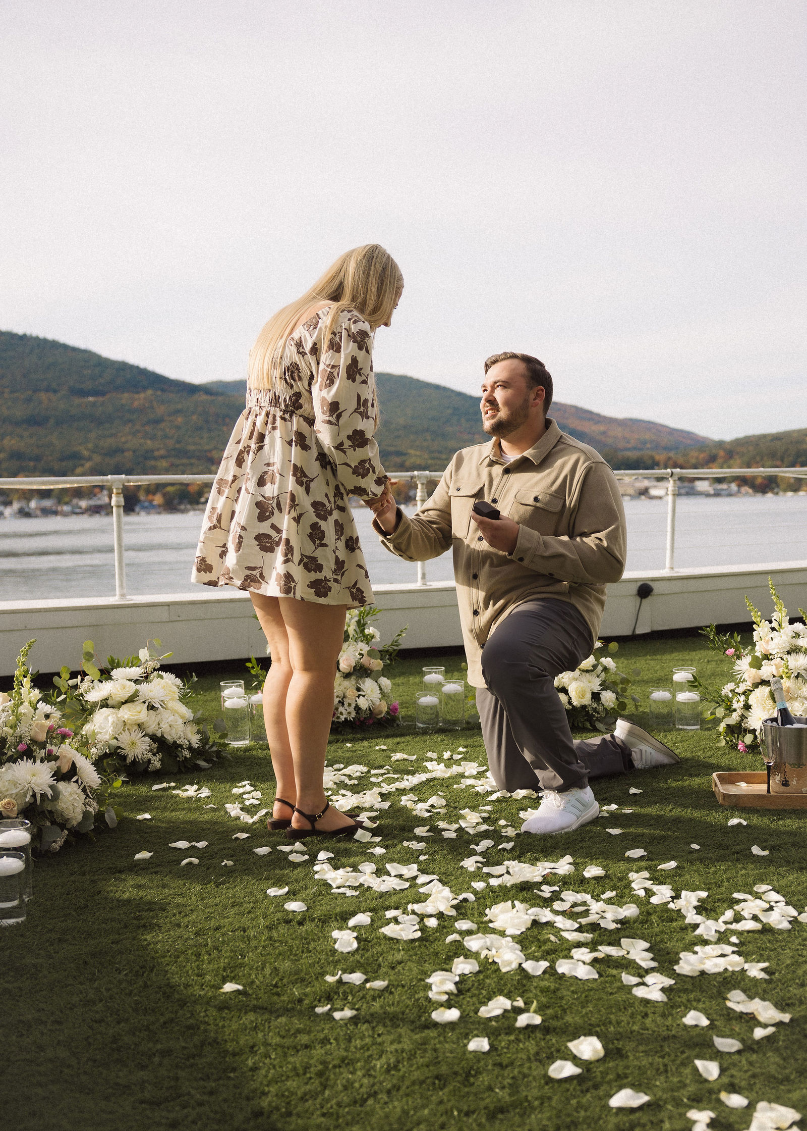 Man on one knee proposing.