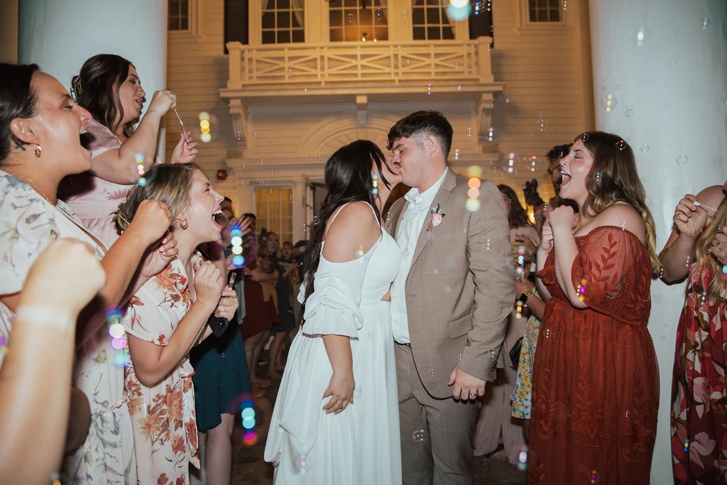 Bride and groom celebrating their evening exit outside The Manor House