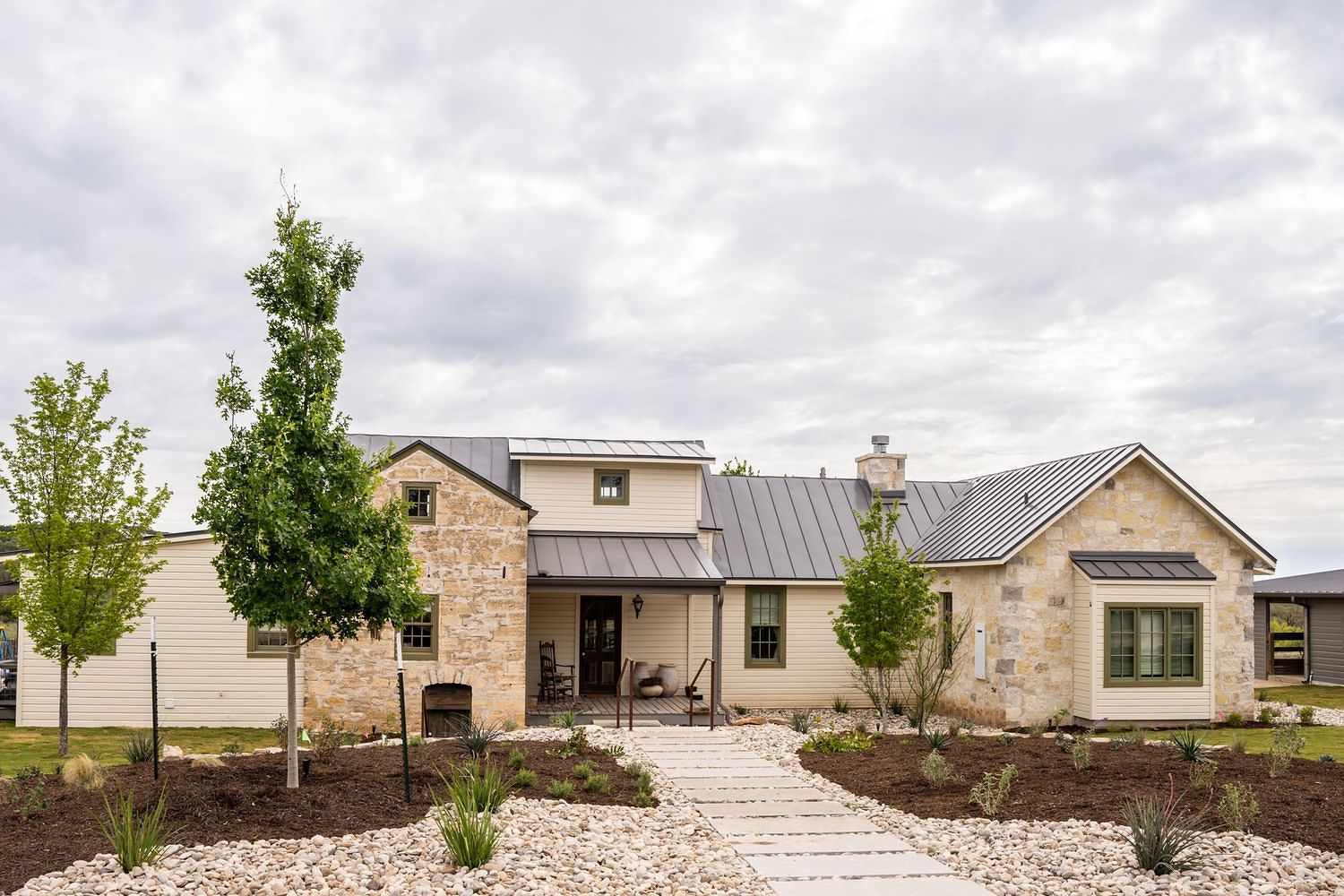 Stone and metal-roof custom home built by Fusion Master Builders in the Texas Hill Country