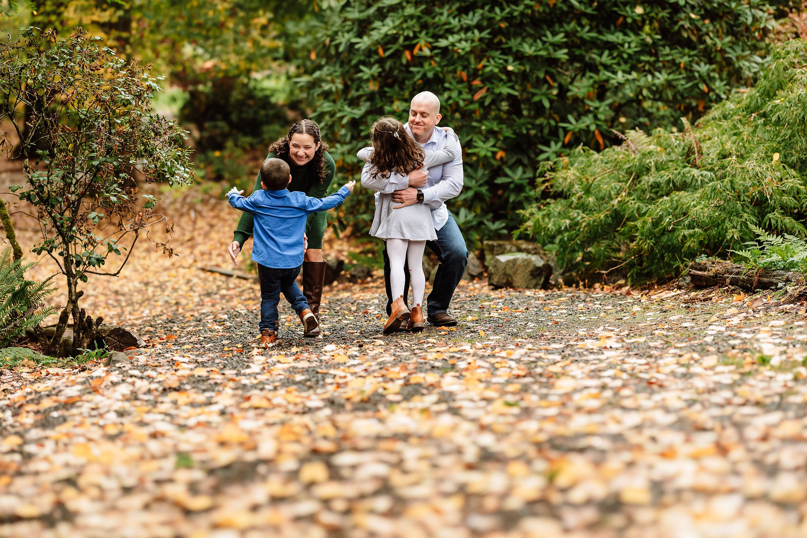 Family walking together holding hands outdoors in Portland