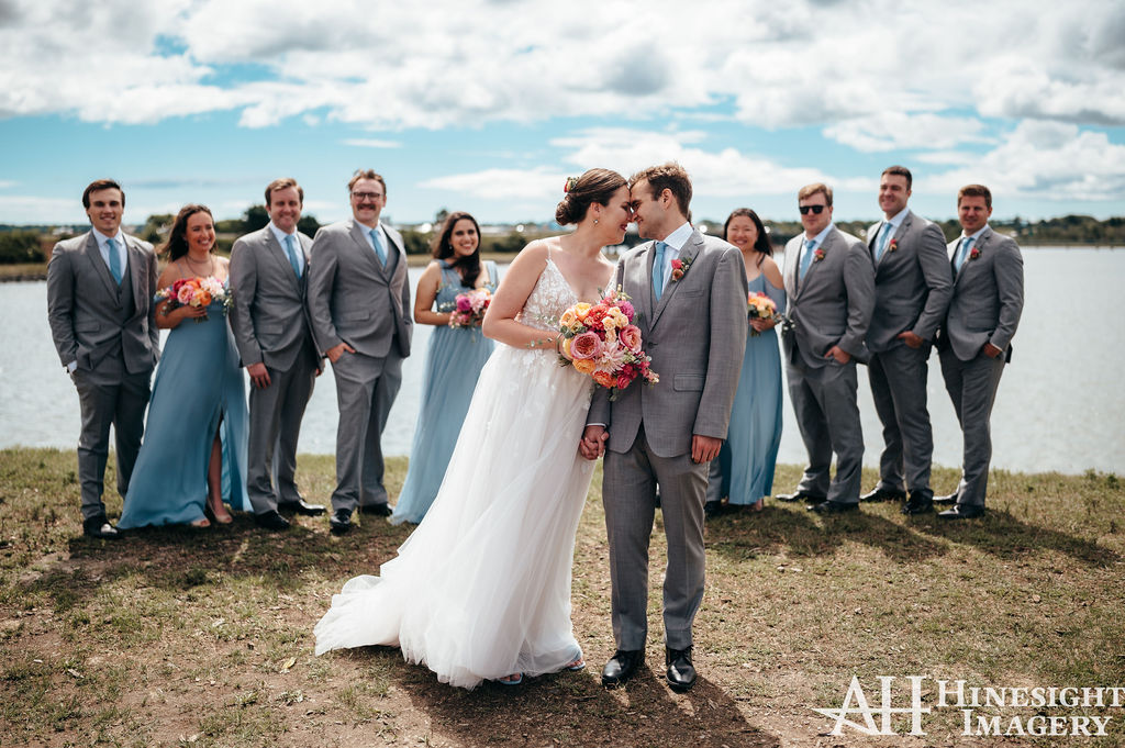 Wedding party posing by the water