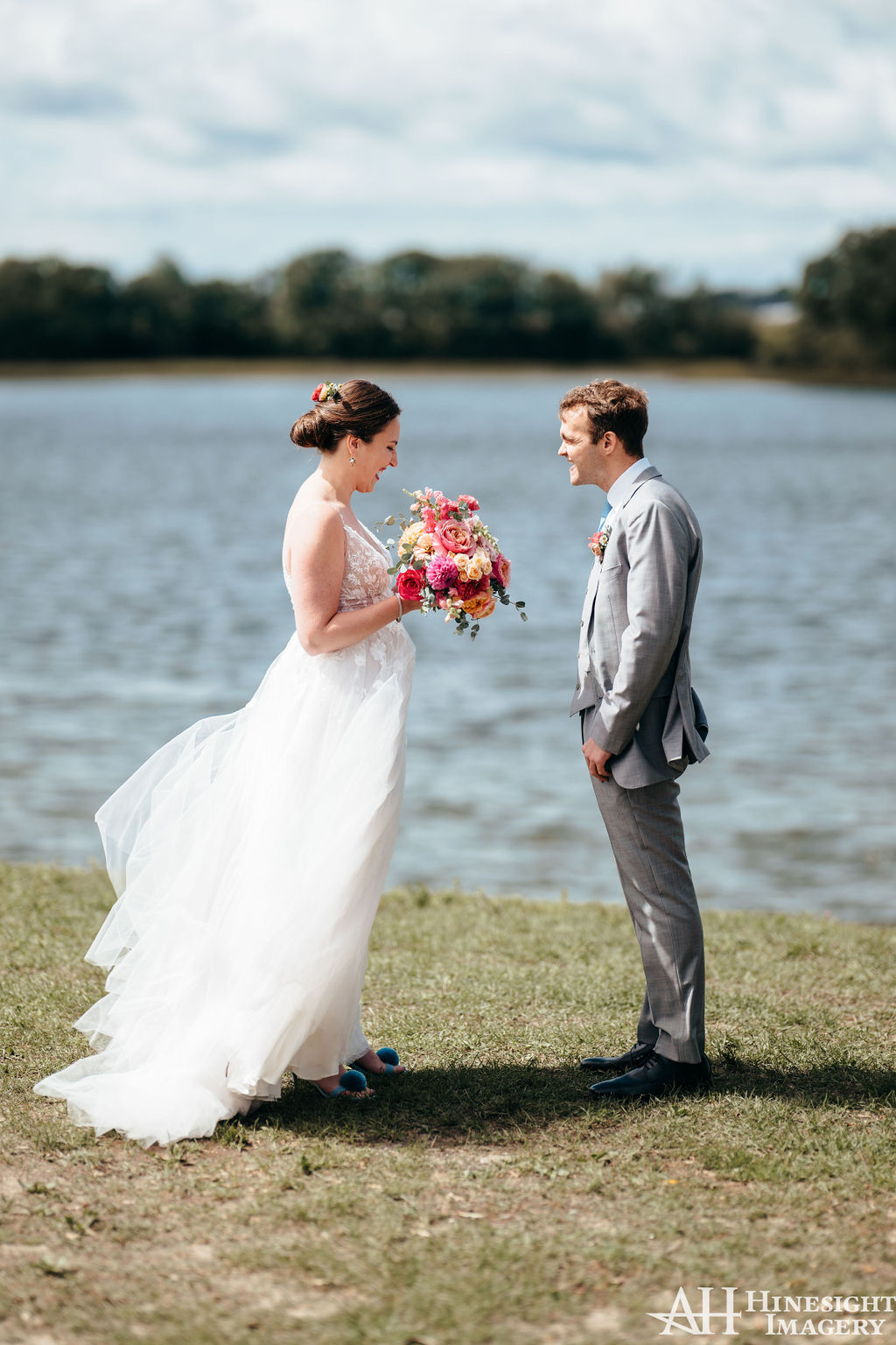 Couple standing by the water holding hands