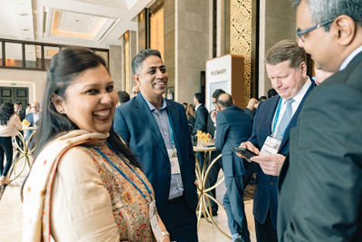 Delegate in yellow speaking with another guest at the J.P. Morgan Annual India Conference