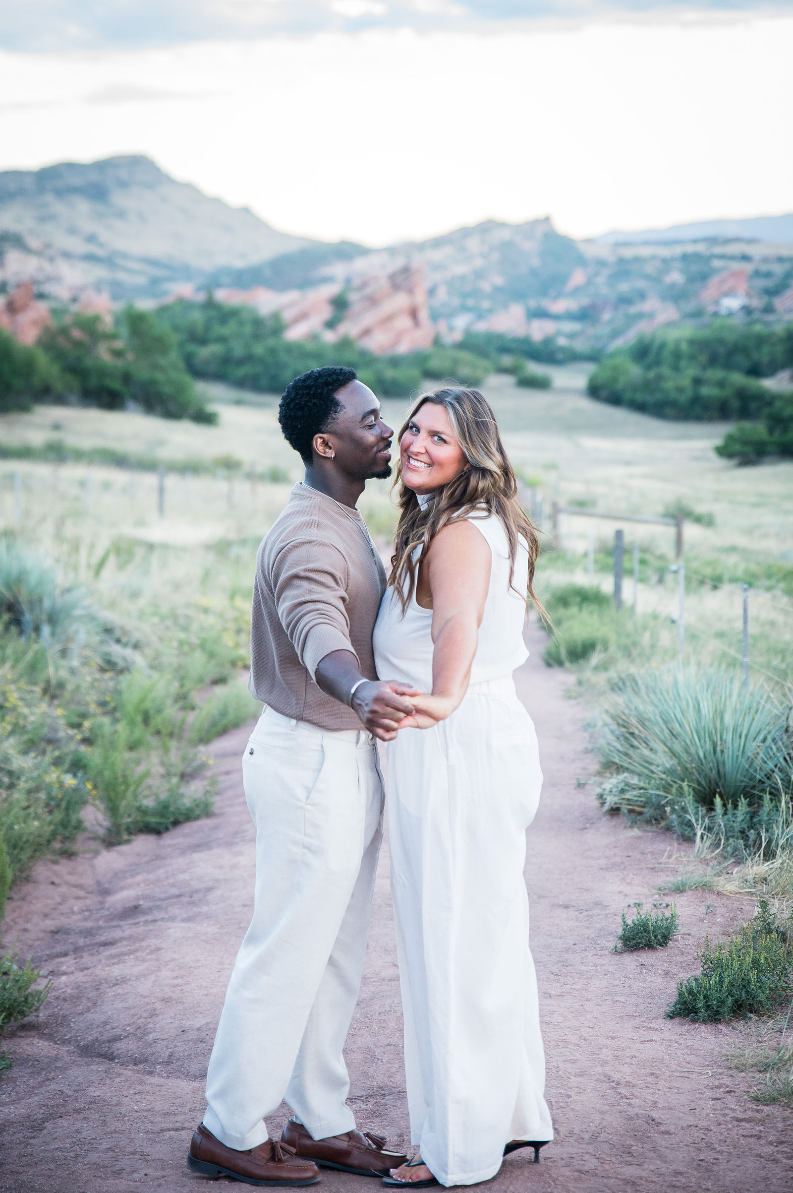 Couple in a warm taupe sweater and long white dress during a fall engagement session in Colorado