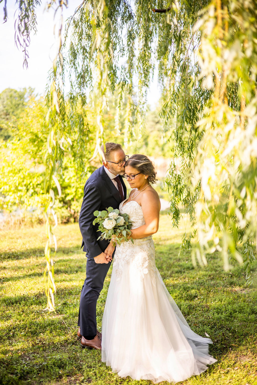 Christine and Mark framed by willow branches