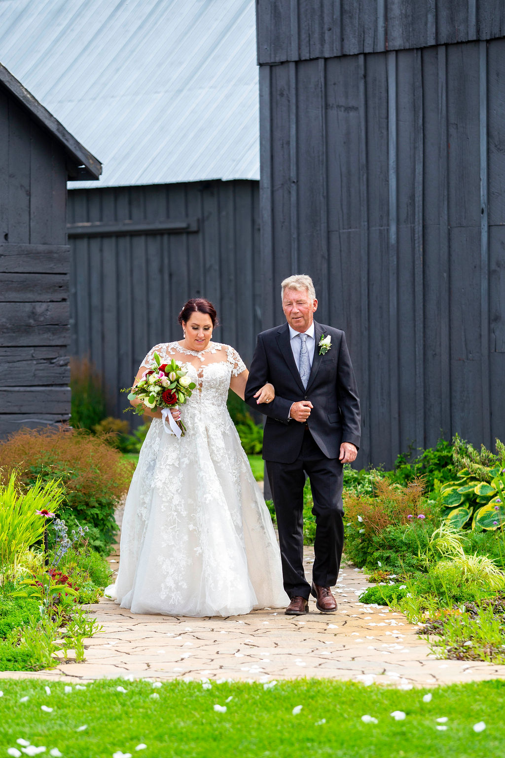 Kelsey walking to the ceremony beside the barn