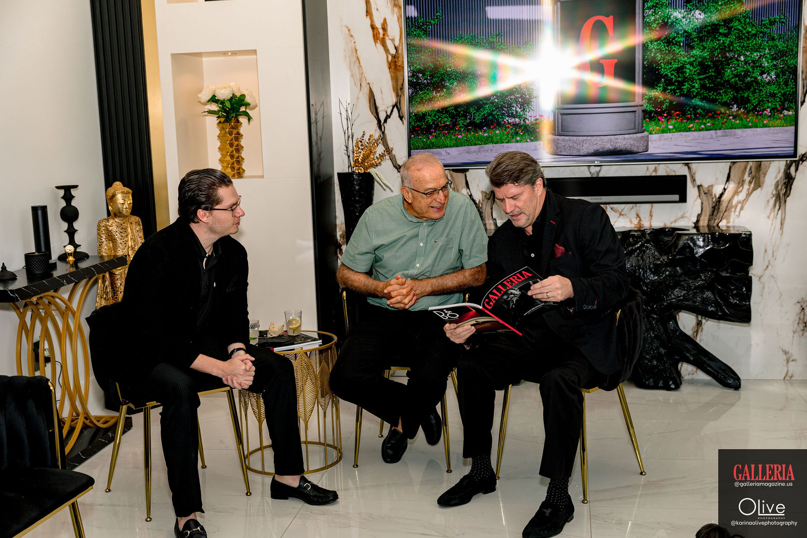 Three guests seated, one reading the first issue.