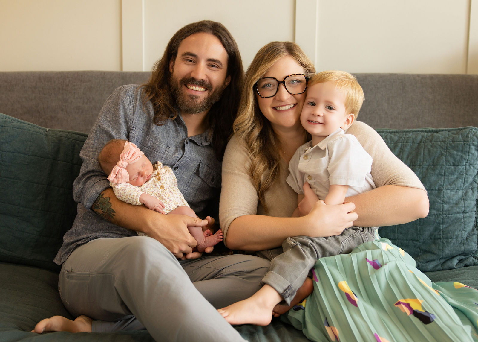 Salt Lake City in-home newborn photography featuring parent holding baby with soft neutral tones