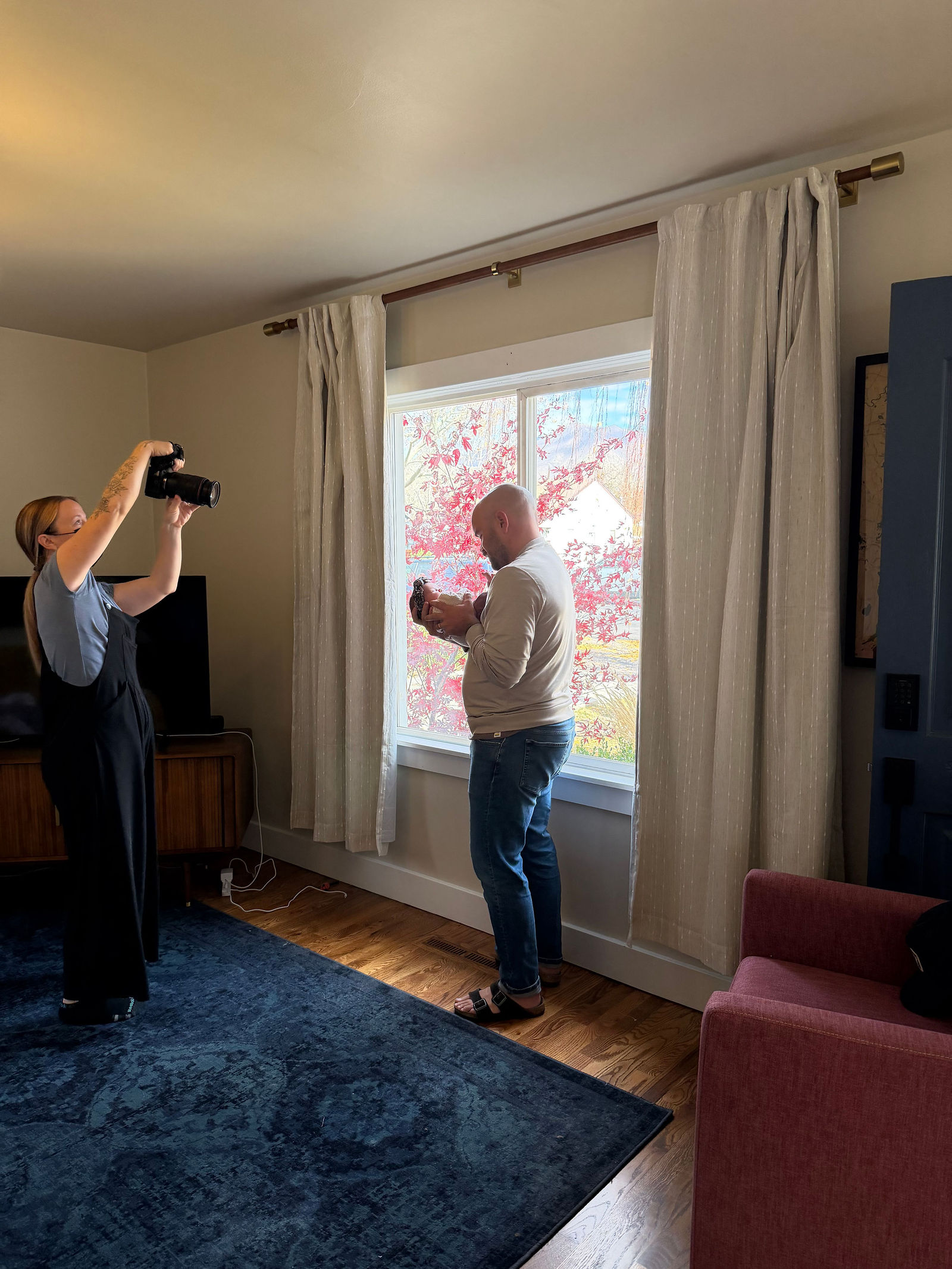 Behind the scenes of Salt Lake City newborn photographer posing baby safely with parent nearby