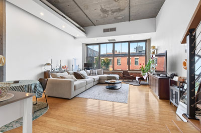 Bright Boston loft living room with sectional and city views