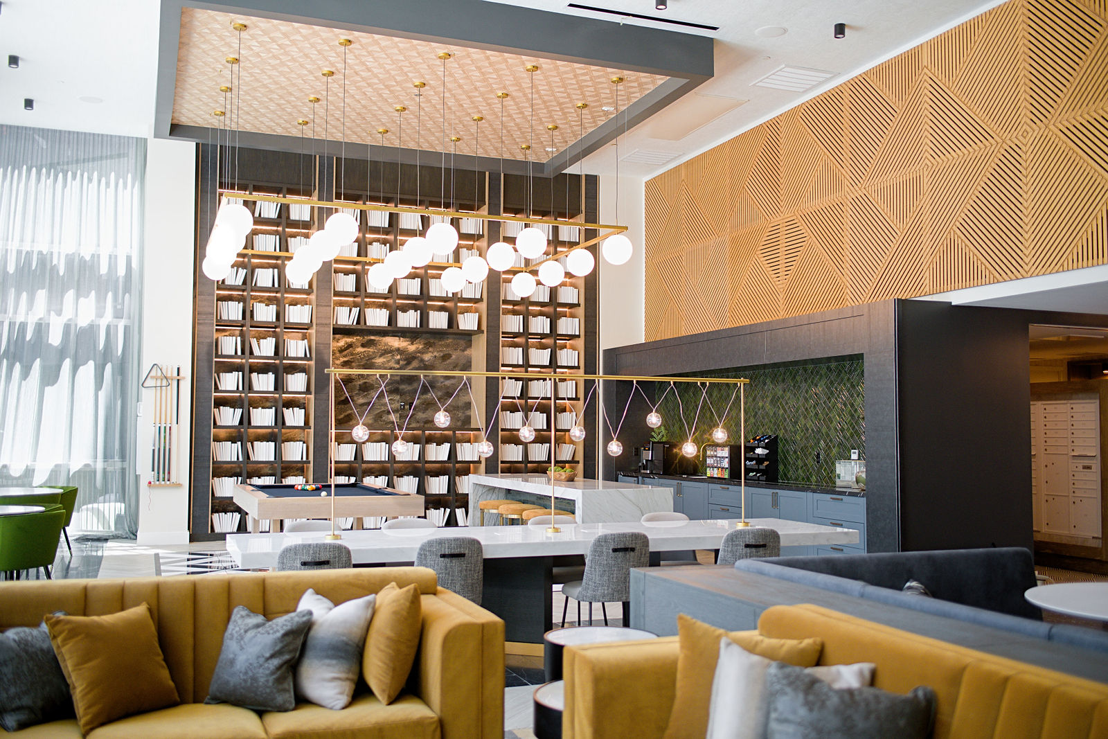Echo Property lounge with architectural wood details, pendant lights and inviting seating