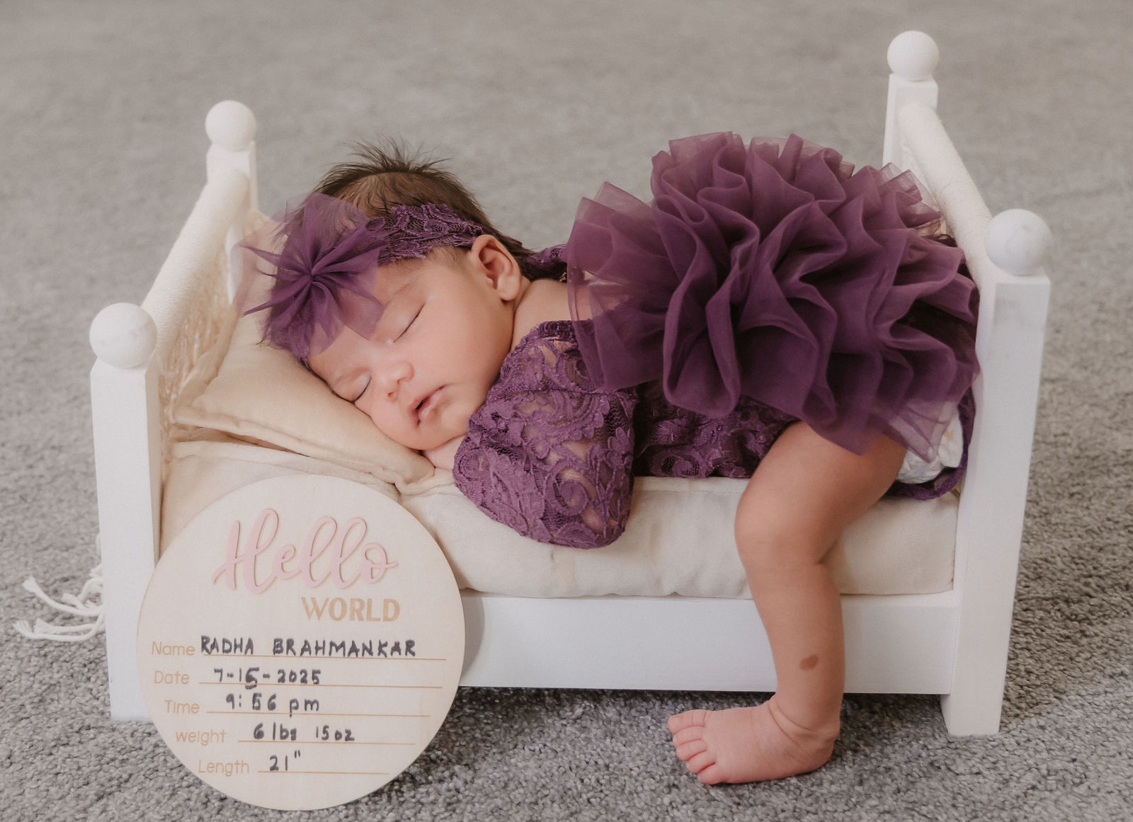 Newborn on tiny bed portrait