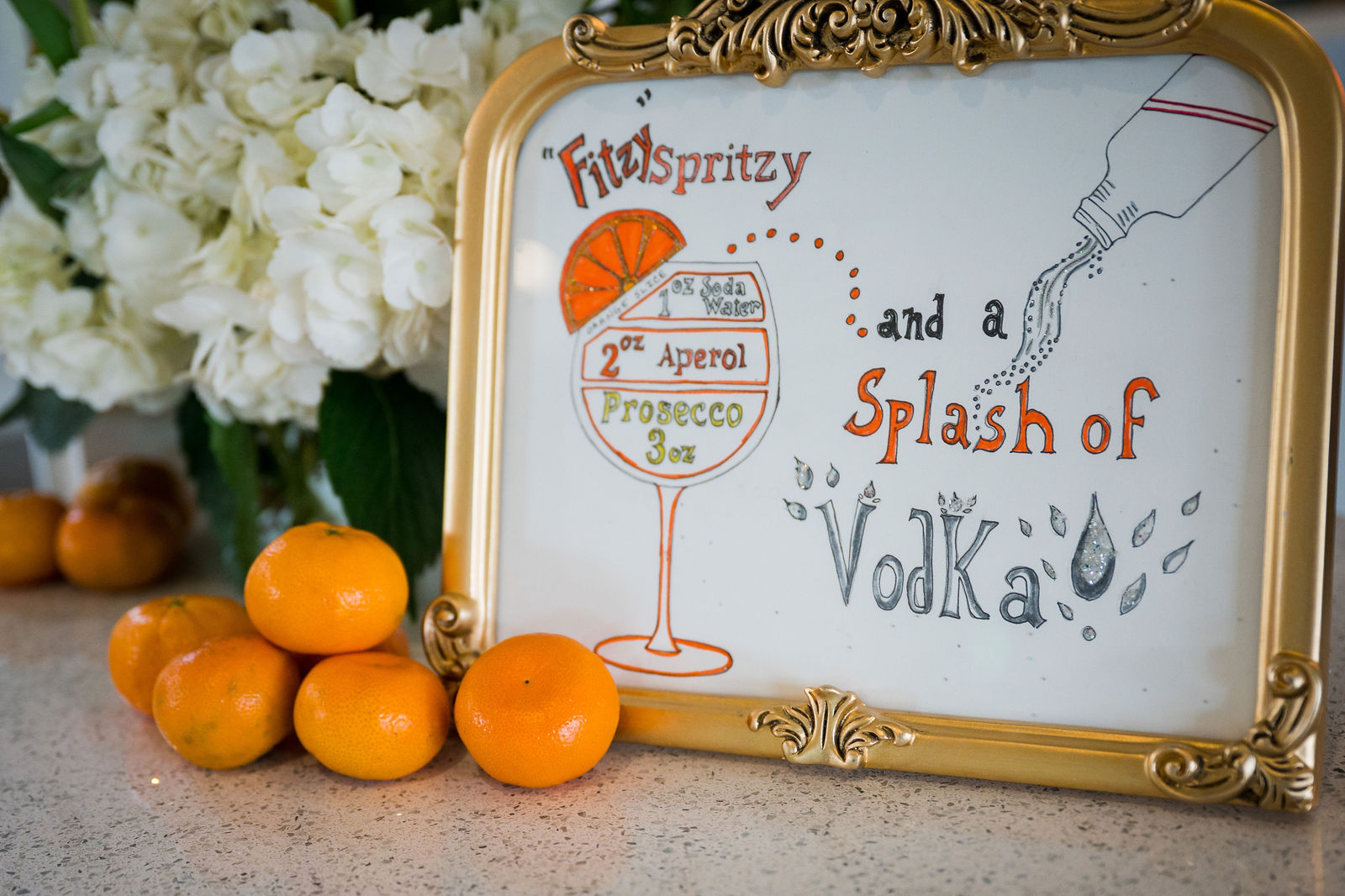 Signature drink sign with oranges at a Morrison Colorado wedding reception