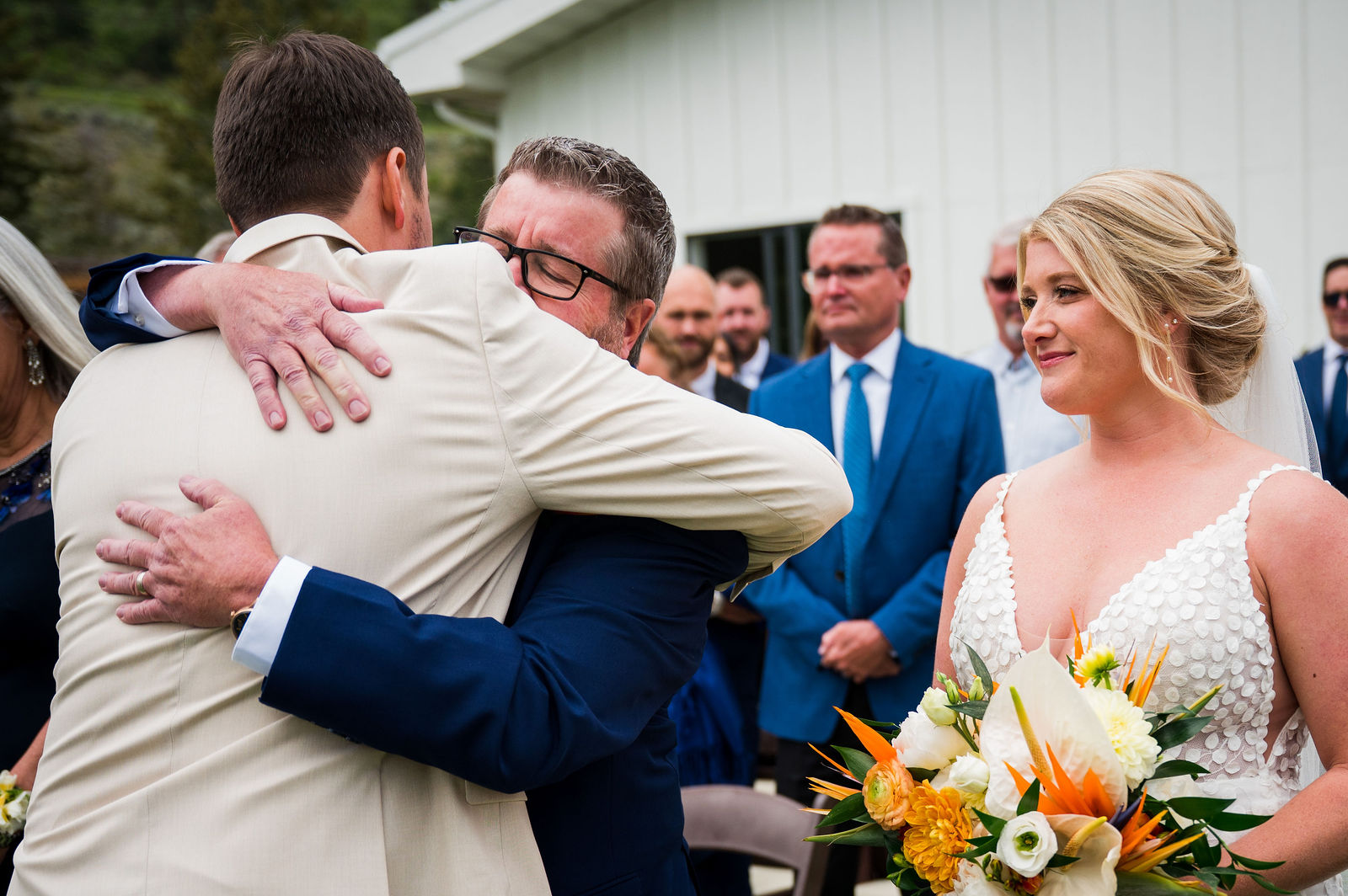 Father of the bride hugging the groom at a Morrison Colorado wedding ceremony