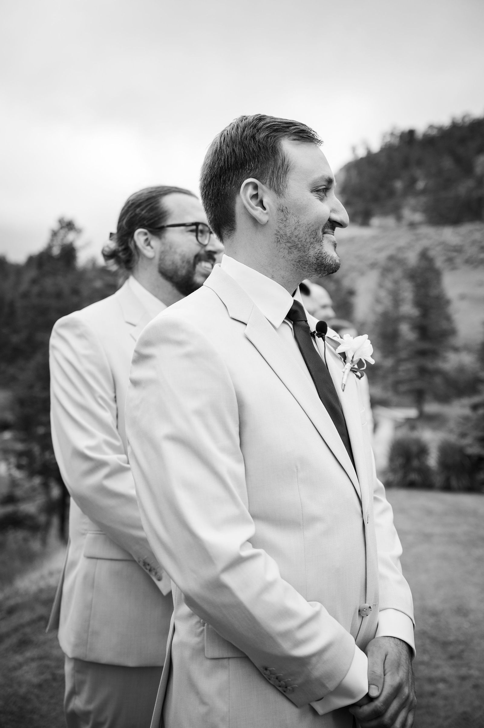 Groom watching his bride walk down the aisle at The Woodlands Colorado