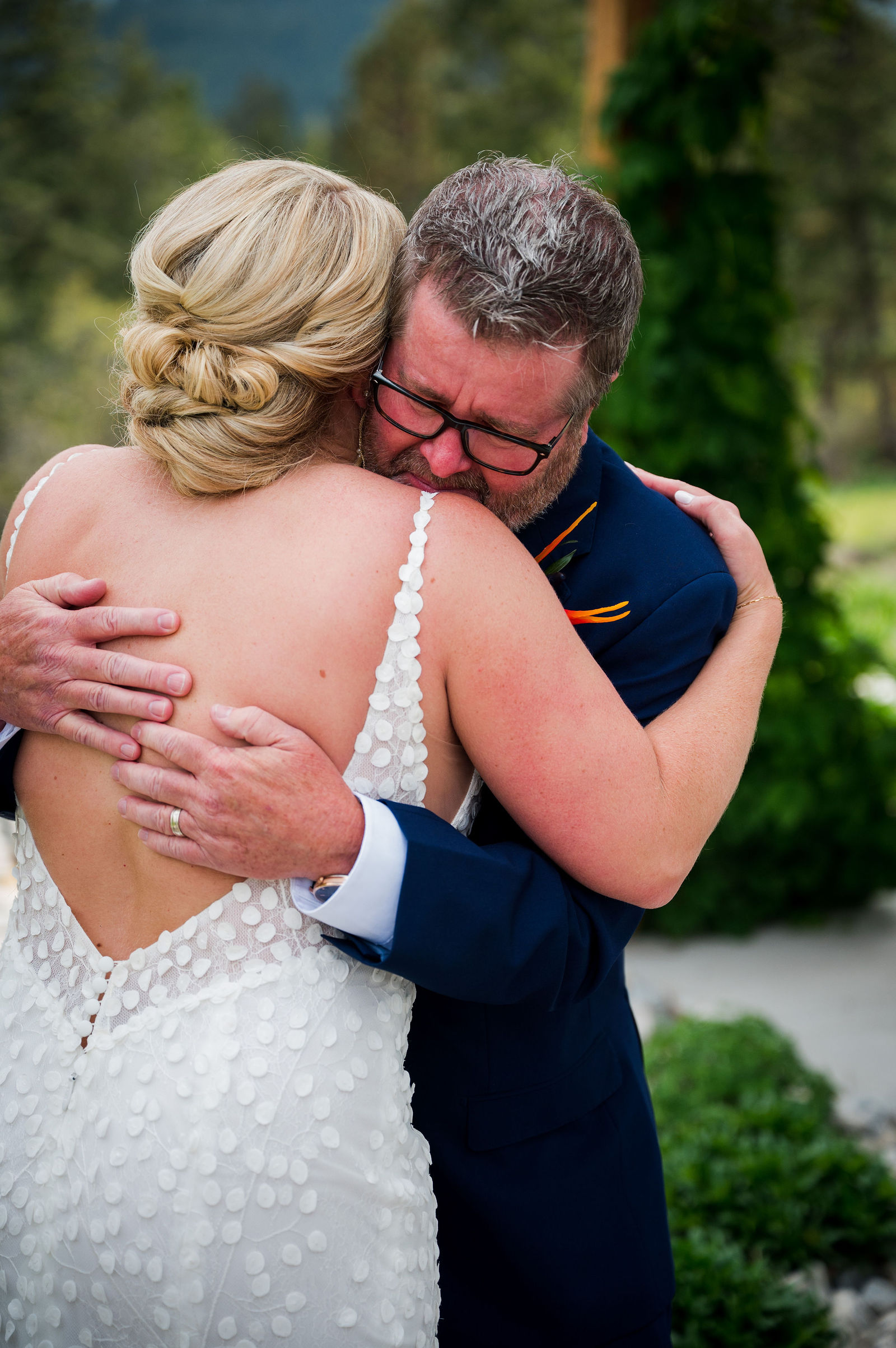 Bride and her father embracing before her Woodlands Colorado wedding