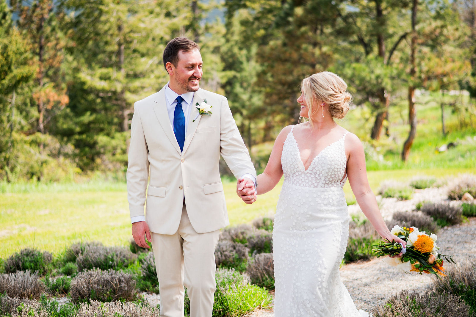 Bride and groom walking and laughing together at The Woodlands Colorado