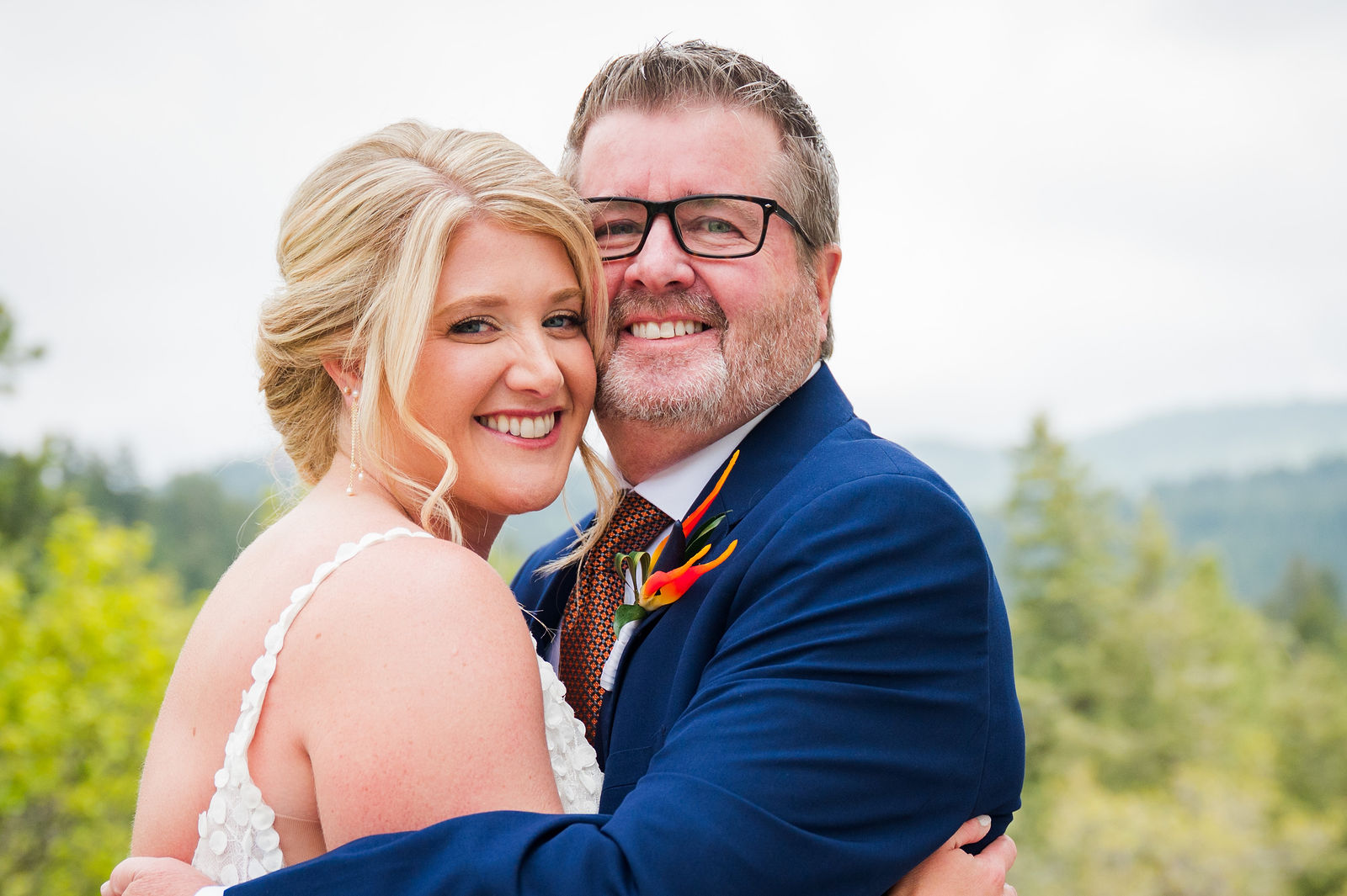 Bride and her father smiling together before her Colorado wedding ceremony