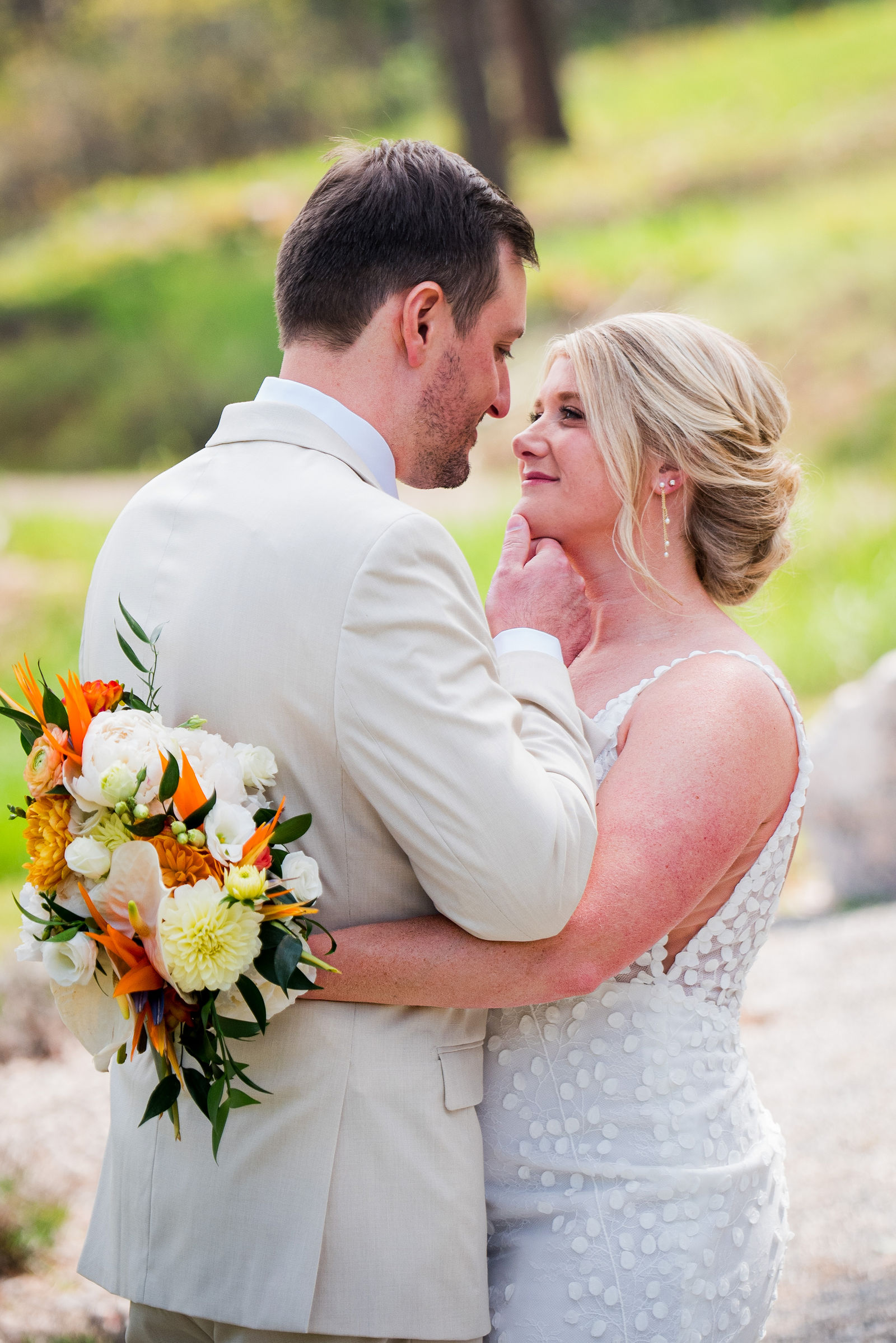 Bride and groom forehead to forehead with a Bird of Paradise bouquet in Colorado