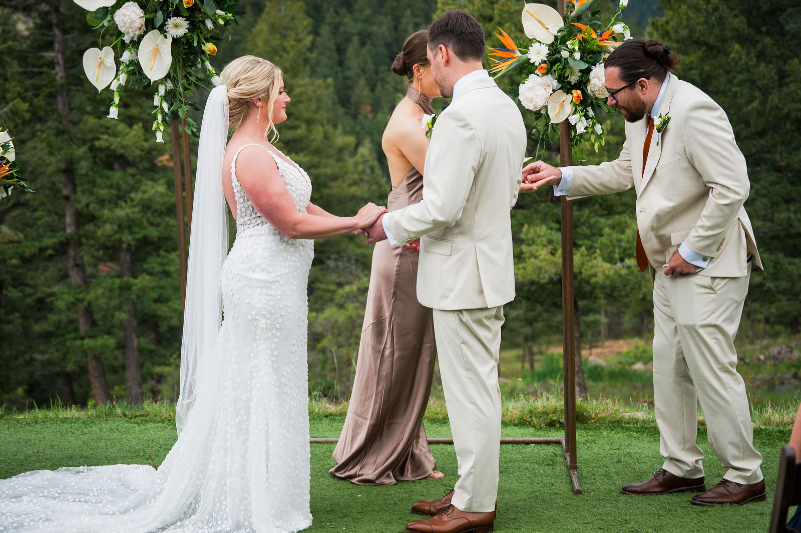 Exchanging rings during a wedding ceremony at The Woodlands Colorado