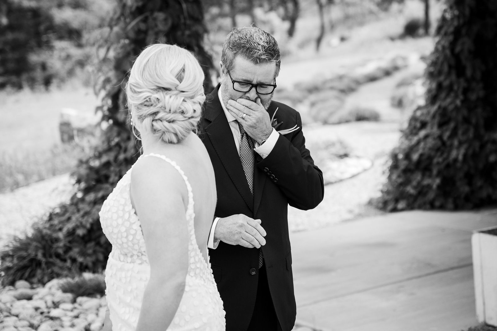 Bride hugging her father during their first look at a Colorado mountain wedding