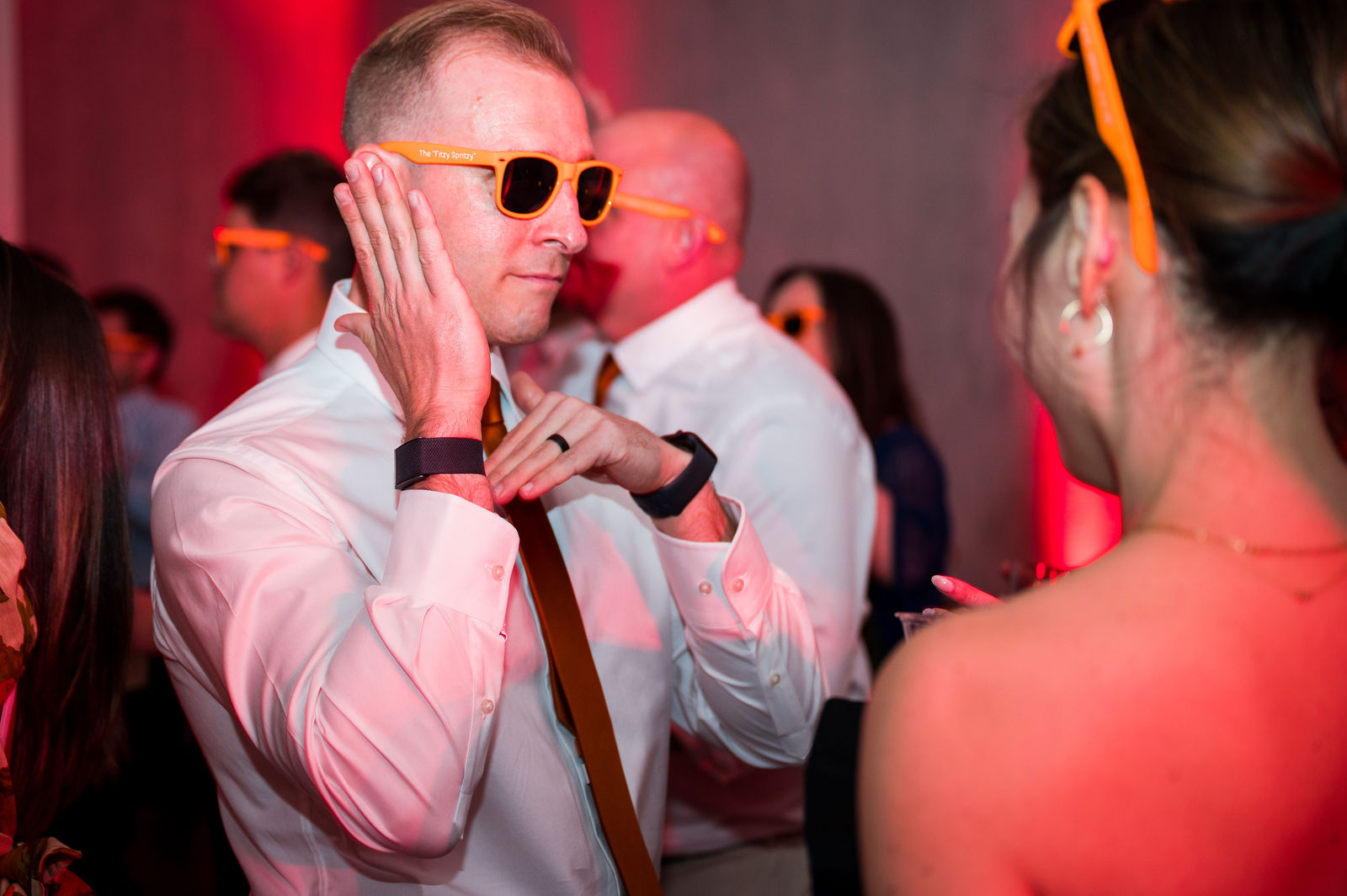 Wedding guests in custom sunglasses on the dance floor in Colorado
