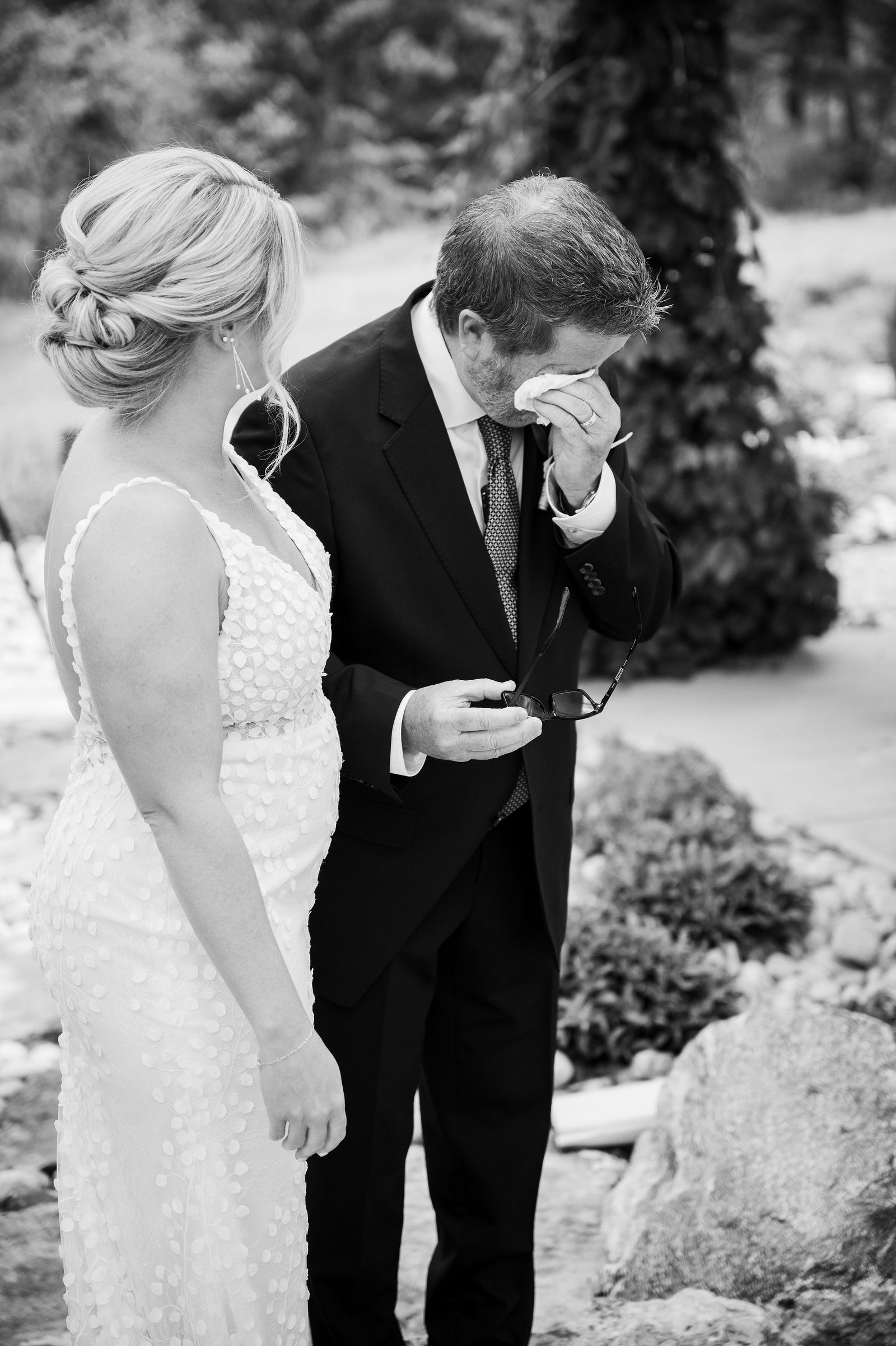 Father of the bride wiping his eyes during a first look in Morrison Colorado