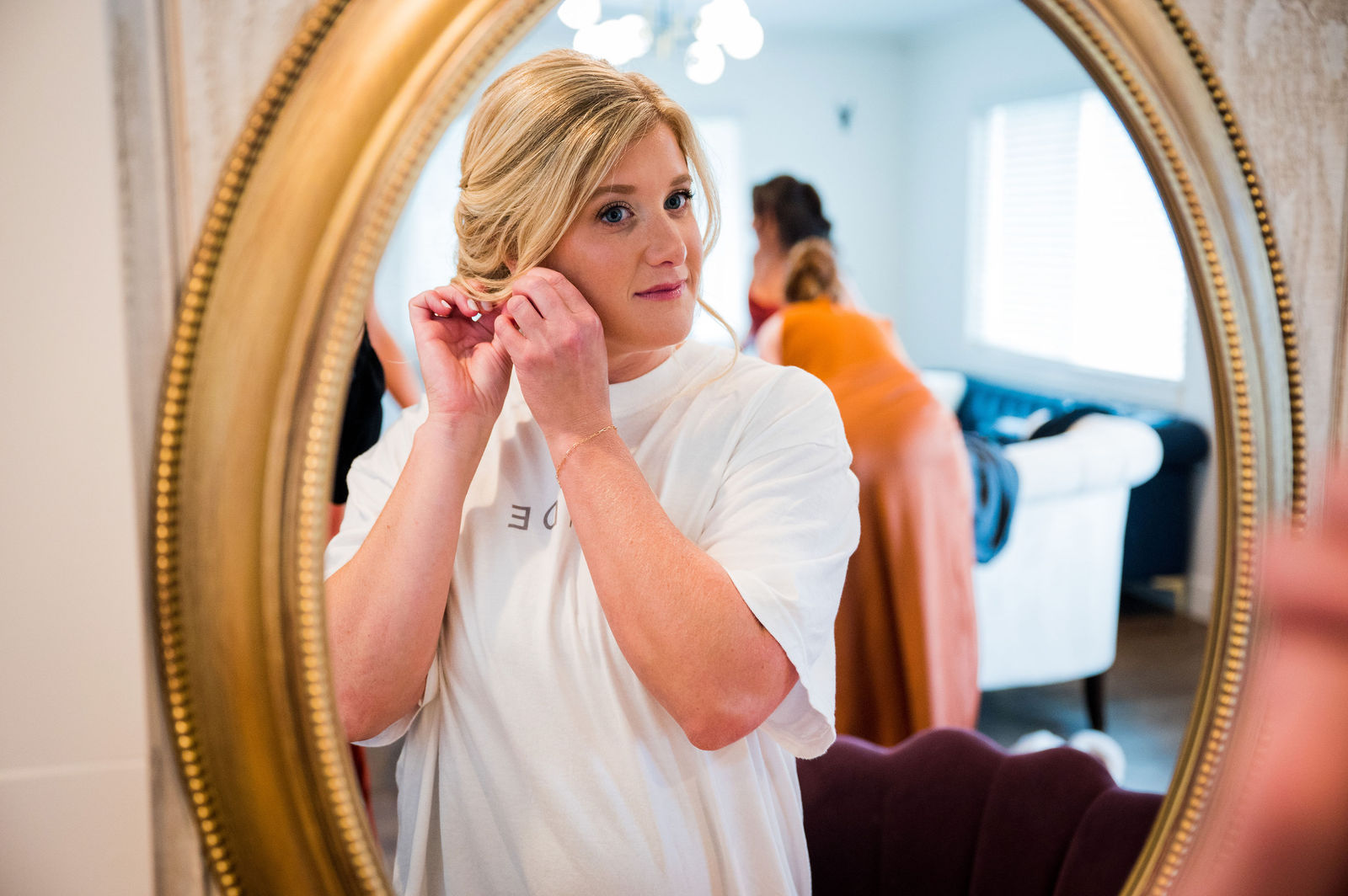 Bride doing her makeup in the mirror before her Morrison Colorado wedding